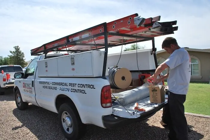 KY-KO technician loading home sealing supplies from his truck