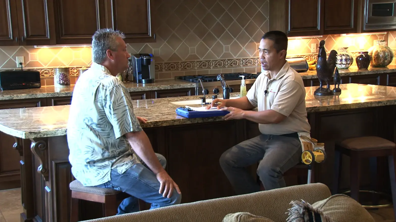 Technician walking a homeowner through the inspection findings