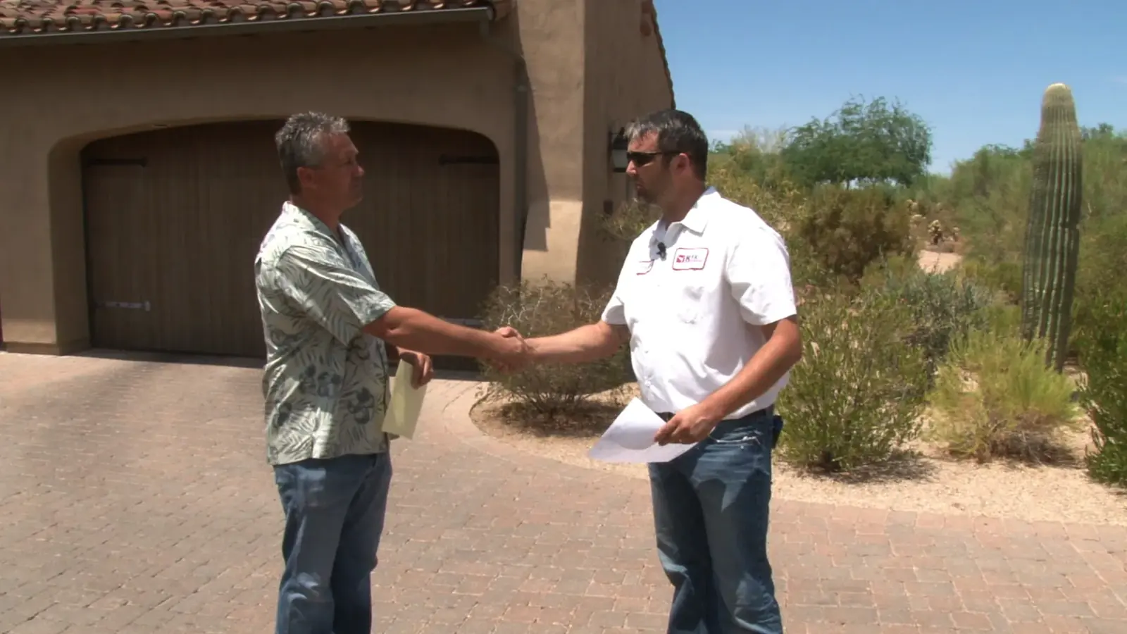 KY-KO technician shaking hands with a homeowner in the driveway