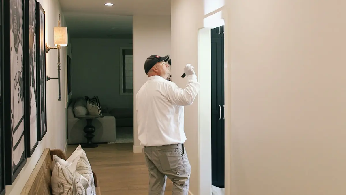 KY-KO technician inspecting a hallway for pests