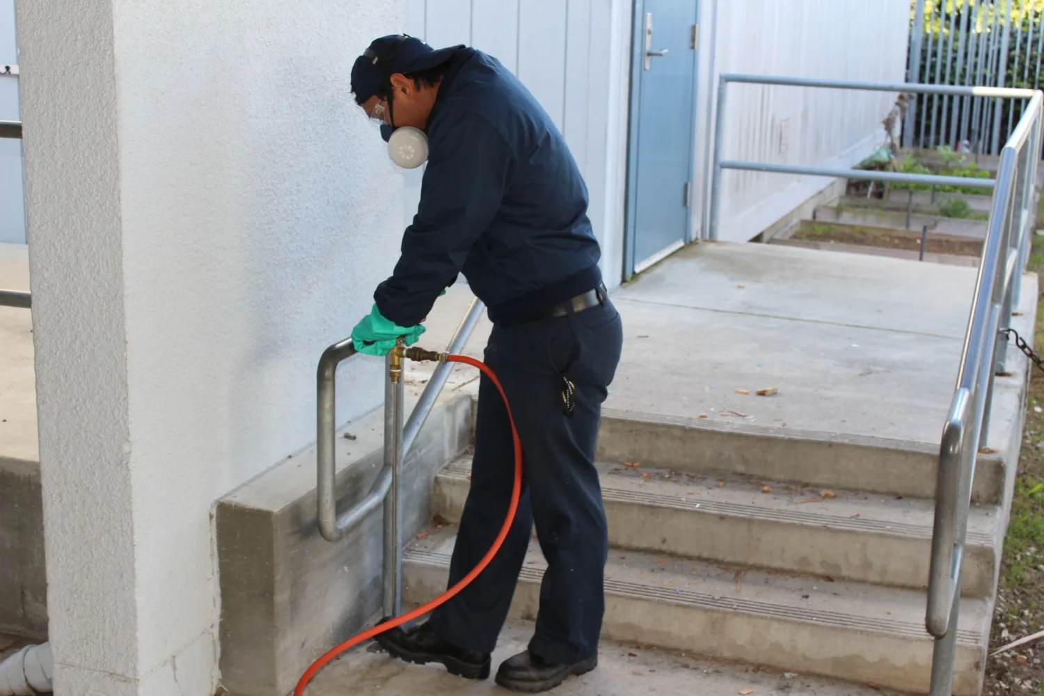 KY-KO technician treating front steps for termites