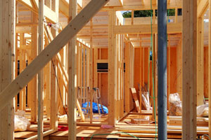 A KY-KO tech applies pest control treatment to a building under construction, protecting it against termites and pests.
