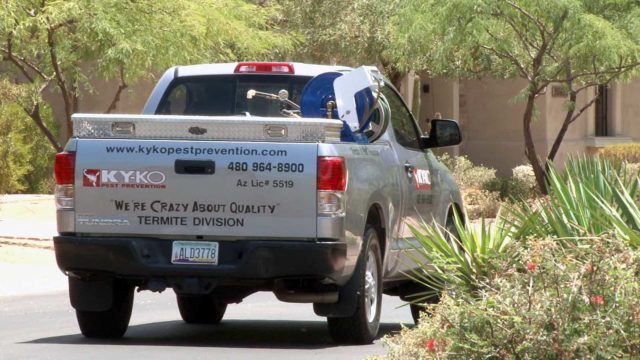 A KY-KO service truck drives out to its next job: a free termite inspection here in Phoenix.