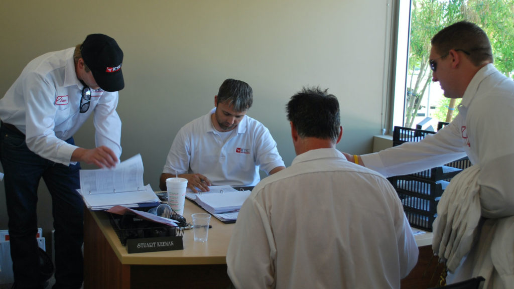 Our team of pest and termite techs gathers around a desk in our office to plan out an upcoming commercial project.