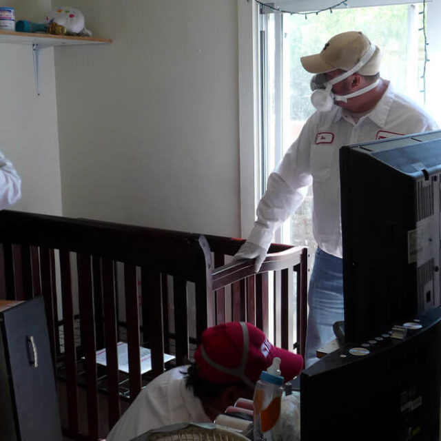 Two KY-KO Pest technicians inspect a home for possible bed bugs here in Mesa, AZ.