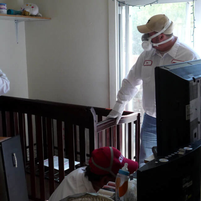 Two KY-KO Pest technicians inspect a home for possible bed bugs here in Mesa, AZ.